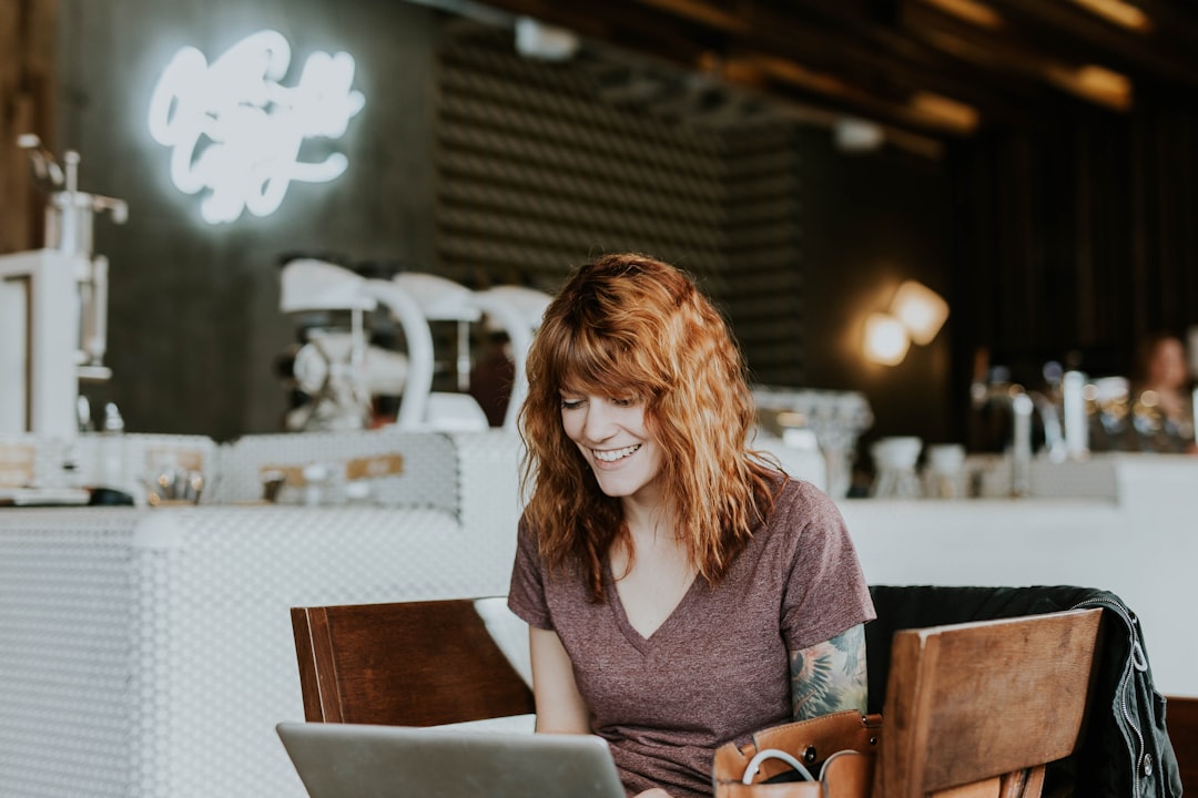 Woman using laptop representing running a reseller hosting business